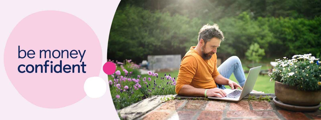 Person sat in garden using laptop