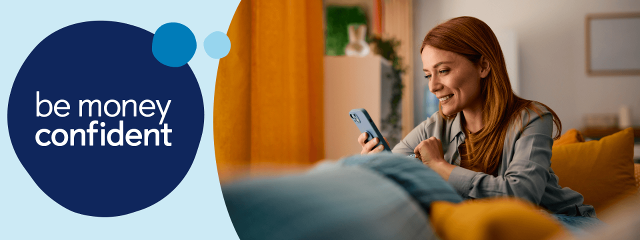 Customer on sofa looking at a mobile phone screen.