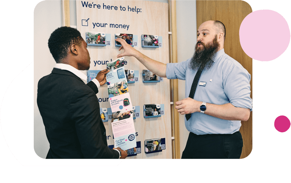 People in branch having discussion next to brochures